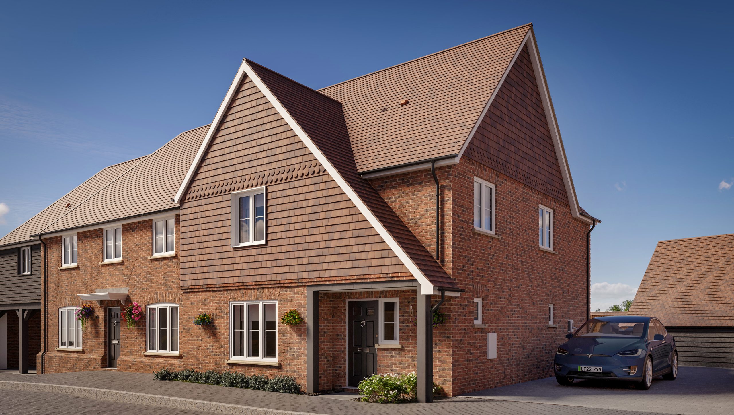 New two-story brick house with tiled roof and parked car under a sunny sky.