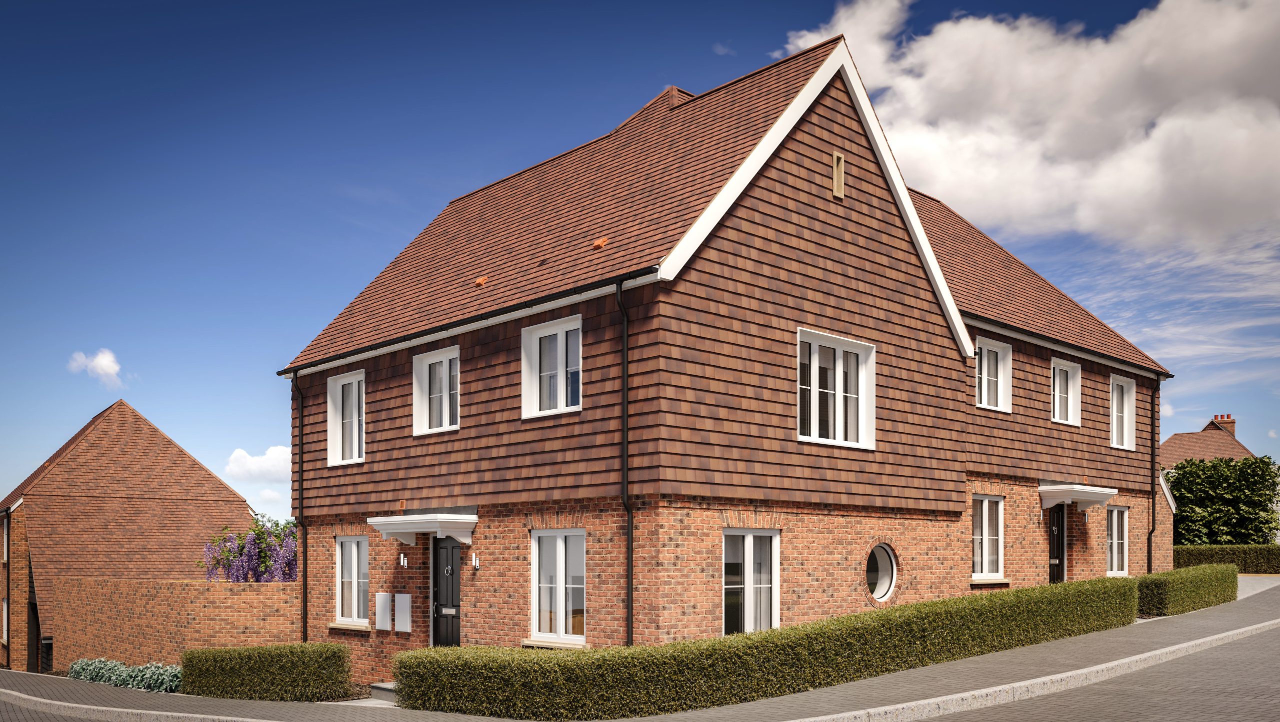 New semi-detached two-story brick house with a tiled roof and a round widow on the ground floor.